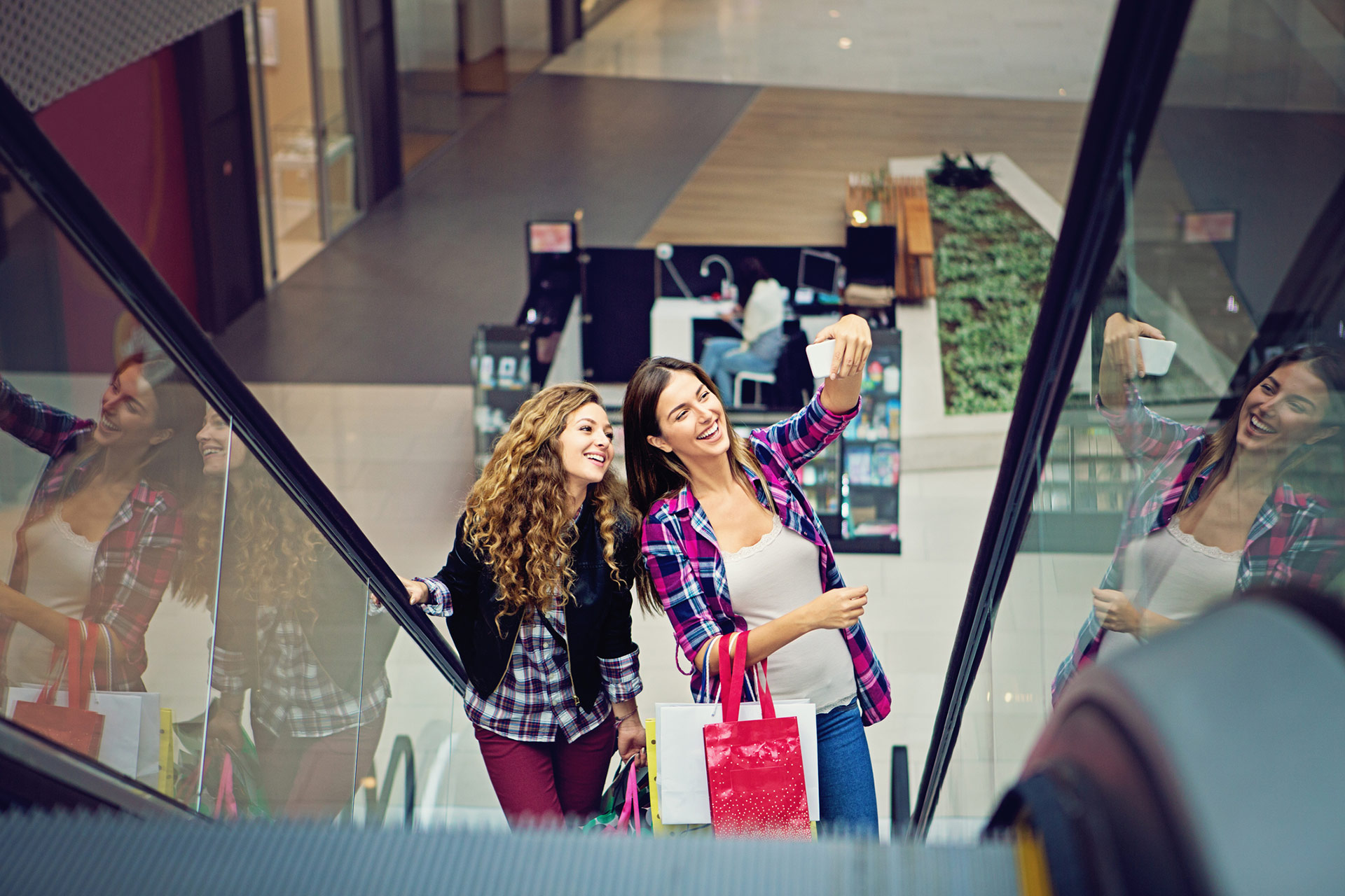 Happy girls shopping in a modern shopping mall